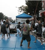 Village of Patchogue, Alive After Five (August 20, 2004): Push Hands and Pushing Staff demonstrations (from L to R) Paul Adago, Jr., & Ed O'Connell, Patricia Hsieh & Francesca DeStefano, Neal Stark & Laoshi Laurince McElroy.