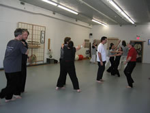 In the Kwoon, ABC T'ai Chi with Spencer Gee (February 2005): A mixture of players from various arts -- T'ai Chi, Aikido, and Jun Ji Do -- practice Chin Na and uprooting techniques during a T'ai Chi Applications seminar. 