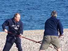 Cedar Beach, Long Island (January 1, 2005): Students Ed O'Connell (L) and John Davis (R) play Pushing Staff on the beach to "warm-up" for a North Shore Polar Bear dive on New Year's Day 2005.