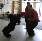 In the Kwoon, ABC T'ai Chi with Spencer Gee (May 2005): Mr. Gee working with seminar participant, Raquel Romaine, during a T'ai Chi Applications seminar. 