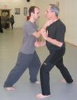 In the Kwoon, ABC T'ai Chi with Spencer Gee (October 2005): Joel Valario (L) with Spencer Gee's event coordinator Tony Cutaia playing a variation on the application of Brush Knee Step & Strike during the fourth return of ABC T'ai Chi to the studio.