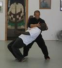 In the Kwoon, ABC T'ai Chi with Spencer Gee (May 2006): Mr. Gee executes a take down, using the knee as a contact point, against seminar participant Sensei Calmut Woods from the Talented 10th Dojo in Brooklyn.