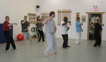 In the Kwoon, ABC T'ai Chi with Spencer Gee (May 2006): Spencer Gee (leading R) taking seminar participants through the basics of the Cheng Man-Ching Yang-style Short Form with an emphasis on coiling energy (Chan-si).