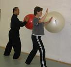 In the Kwoon, ABC T'ai Chi with Spencer Gee (May 2006): Spencer Gee (L) working with Water Tiger School student Patricia Hsieh on using an exercise ball to explore the circular coiling movements in Tai Chi during Mr. Gees fifth visiting seminar at the studio.
