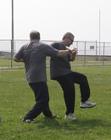 Tai Chi in the Park (May 27, 2006): Si-Hing Ed OConnell (L) takes advantage of Laoshi Laurince McElroys use of muscular force in a demonstration of Water Tiger Schools Grappling Push Hands exercise.