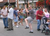 Village of Patchogue, Alive After Five (July 7, 2006): The true nature of Guerrilla Tai Chi is demonstrated as Laoshi Laurince McElroy, in High Pat on Horse, deals with adjusting the Medium-Frame Yang-style Long Form to the flow of the crowd around him.