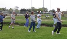 Tai Chi in the Park (May 12, 2007): On another gorgeous Saturday morning in Shorefront Park, Laoshi Laurince McElroy (R) introduces the group to the Water Tiger Playing the Scales exercise Walking the Rails with One Rotation.