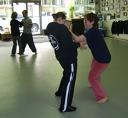 In the Kwoon, Perspectives on Tai Chi Push Hands (November 2007): Enjoying the unfolding play of Two-Hand Application Push Hands, Si-Goo Mui Francesca DeStefano (R) takes Kathy Schwager off her vertical alignment. In the background, Si-Hing Joel Valerio (R) plays the exercise with Rita Valentin.