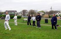 Tai Chi in the Park (May 3, 2008): At the end of the rather brisk first morning in the park finishes as Laoshi Laurince McElroy talks the small group of participants through the finer points of Rock Back & forth to Remove Stagnation from Water Tigers Tai Chi Qigong Breathing Set.