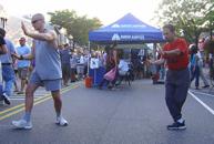 Village of Patchogue, Alive After Five (August 1, 2008): Playing in synchronicity through the usual chaos that is the Guerrilla Tai Chi experience, Laoshi Laurince McElroy (L) and Si-Suk Paul Adago, Jr., bring Water Tigers 24-Posture Form into closing with Circle Fist.
