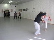 In the Kwoon, Introduction to Tai Chi Straight Sword (February 2009): A mixture of Water Tiger students with students from Shaolin Kung Fu Studios -  Medford enjoy a round of Push Sword.