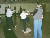 World T'ai Chi & Qigong Day; South Ocean Middle School Gymnasium, Patchogue NY (April 6, 2002): Spencer Gee, Spencer Gee Wellness Corp in Old Westbury, challenging the balance and capturing the attention of attendees in the South Ocean Middle School gym.