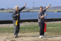 World Tai Chi & Qigong Day; Shorefront Park, Patchogue NY (April 24, 2004): Event host Laoshi Laurince McElroy (R) and Mr. Phil White, event participant and fellow member of the MSN Tai Chi Club, playing an orthodox straight sword form.