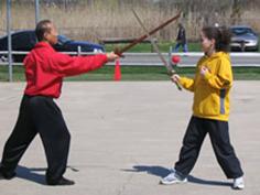 World Tai Chi & Qigong Day; Shorefront Park, Patchogue NY (April 24, 2004): Spencer Gee (toward Right wearing red), from the Spencer Gee Wellness Corp in Old Westbury, leads a workshop on his "T'ai Chi Workout."