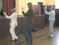World Tai Chi & Qigong Day; St. Francis De Sales Parish Hall, Patchogue NY (April 30, 2005): Judith Budd-Walsh, Harmonious Movement Tai Chi (L), guides her group through the movements of the first third of the Yang-style Long Form.
