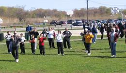 World Tai Chi & Qigong Day; Shorefront Park, Patchogue NY (April 29, 2006): Pockets of Tai Chi in Patchogues Shorefront Park. Laoshi Laurince McElroy (in foreground) leading a group in The Tiger Frolics; Bob Klein, Long Island School of Tai-Chi-Chuan, is playing aspects of Yang-style (group facing Right); and Spencer Gee, Spencer Gee Wellness Center, is putting people through their paces with his T'ai Chi Workout (far background). Other workshops, not pictured, were led by Sifu James Robinson and Philip White.