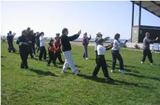 World Tai Chi & Qigong Day; Shorefront Park, Patchogue NY (April 29, 2006): Laoshi Laurince McElroy helping participants stretch like Tigers during his workshop on the Tiger Frolics.