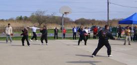 World Tai Chi & Qigong Day; Shorefront Park, Patchogue NY (April 26, 2008): The very popular Facilitators Demonstrations returned this year to demonstrate how differences do not interfere with the concept of One World  One Breath (L to R) Sifu Tyrone Wei Wicksman, Zhang Style Tai Chi Chuan, playing the first section of the Zhang-style form; Nancy Fiano, Dojo of the Dancing Dragon, with friend and fellow instructor Mike Dalia completing the Cheng Man-Ch-ing Yang style short form; Laoshi Laurince McElroy (in between Ms. Fiano & Mr. Dalia) with Water Tigers Yang-influenced Straight Sword Form; Spencer Gee, Spencer Gee Wellness Corporation, weaving together Yang-Style postures with a detailed focus on Chan Si; Judith Budd-Walsh, Harmonious Movement, modifies the movement count to show the entire Yang-Style Long Form from her lineage; Sifu Michael Evans, Shaolin Kung-fu Studios, has plenty of safe distance as he demonstrates the 16-posture Yang-style Spear Set; and Bob Klein, Long Island School of Tai-Chi-Chuan, playing the 60-movement Yang-style Short Form from William C. C. Chen.