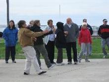 World Tai Chi & Qigong Day; Shorefront Park, Patchogue NY (April 30, 2011): 
Bob Klein and Jean Goulet (in foreground L to R), Long Island School of Tai-Chi-Chuan of Sound Beach, play a form from their lineage during the facilitators demonstration.