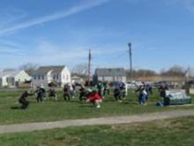 World Tai Chi & Qigong Day; Shorefront Park, Patchogue NY (April 27, 2013): Reaping the benefits of some meridian therapy and some Tibetan Breathing Qigong, participants crouch with Judith Budd-Walsh (L), Harmonious Movement of Port Jefferson Station.