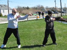 World Tai Chi & Qigong Day  Patchogue (April 25, 2015): During his workshop, Single-Moment Practice: The Magic is in the Minutia, Laoshi Laurince McElroy (L), Water Tiger School of Tai Chi Chuan in Medford, leads Laoshi Joel Valerio of Ozone Park,  through a deep drill into Single Whip from Water Tigers 24-Posture Short Form.