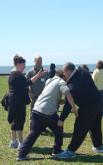 World Tai Chi & Qigong; Shorefront Park, Patchogue NY (April 30, 2016): Our first joint workshop included Teresa White (L), Long Island Tai Chi in Babylon, and Chris Jurak (2nd from L), Mountain Stream Tai Chi and Qigong in Brightwaters. Here, Teresa is giving pointers during her Wu-style portion of their joint Form Meets Function: Comparing Traditional Applications of Pre-Imperial Yang and Northern Wu Styles of Tai Ji Quan.