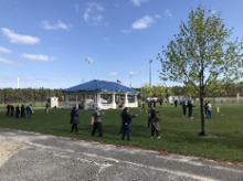 World Tai Chi & Qigong Day; Diamond in the Pines, Coram NY (April 27, 2019): Bright sun, high winds, and lower temperatures combined as groups of brave and bundled souls began the morning with workshops from a diverse group of facilitators: Bob and Jean Klein from Long Island School of T'ai-Chi-Chuan in Sound Beach (far left); Judith Budd-Walsh from Harmonious Movement in Port Jefferson (lower right); Joe Cronin of Bethpage (upper right); and Joel Valerio of Staten Island (background).
