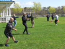 World Tai Chi & Qigong Day; Diamond in the Pines, Coram NY (April 27, 2019): As always during the midmorning facilitator demonstration, the unity of variations is made visually clear through samples from all the different lineages. (L to R) Laoshi Joel Valerio (in grey hoodie, Staten Island), Jean Klein (in blue jacket, Long Island School of T'ai-Chi-Chuan), Elan Abneri (in black, Silent Fist Tai Chi), Bob Klein (in dark olive hoodie, Long Island School of T'ai-Chi-Chuan), and Laoshi Laurince McElroy (in grey sweatshirt, Water Tiger School). Not pictured: Judith Budd-Walsh (Harmonious Movement), Joe Cronin (Bethpage), Bill Donnelly (Green Cloud Kung Fu).