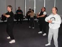 Engelhard Corporation (formally The Collaborative Group, Ltd.), Stony Brook (February 2004): Laurince McElroy of Water Tiger Services leading colleagues in a T'ai Chi Qigong Stretch during a Warrior Wellness session.