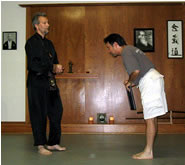 In the Kwoon, Paul Adago, Jr.'s Public Class Certification Ceremony (September 15, 2005): Laoshi Laurince McElroy (L) and Si-Suk Paul Adago, Jr., at the presentation of the certificate to teach Water Tiger School's Grasp Sparrow's Tail to the Four Cardinal Directions in public forums.