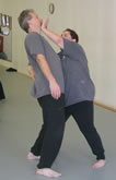 In the Kwoon, ABC T'ai Chi with Spencer Gee (October 2005): April Alexander (R) getting the upper hand on Laoshi Laurince McElroy with a variation on the application of Parting the Wild Horse's Mane during the open hand portion of a T'ai Chi Applications seminar.