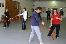 In the Kwoon, Introduction to Tai Chi Straight Sword (March 2007): A handful of Water Tiger School students and one student from another South Shore program play Pushing Sword while McElroy Laoshi observes, comments, and gingerly walks through the moving drill.
