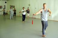 In the Kwoon, Tai Chi Straight Sword  The Journey Continues 1 (June 2007): Polishing the first section of the Water Tiger School 32-posture Orthodox Straight Sword Form, McElroy Laoshi (R) talks and moves through the details of Right Interception with participants following.