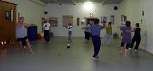 In the Kwoon, Walk Like a Tiger (August 2007): With small furry friends marking the path, Laoshi Laurince McElroy (L) leads participants through the Tiger Walking in the traditional circular pattern of the Wu-Dang Five Animal Frolics.