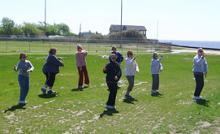 Tai Chi in the Park (May 17, 2008): Staying on one of the few dry patches in the park, participants experience the details of Medium-Frame Yang-style Tai Chis Wave Hands Like Clouds with Laoshi Laurince McElroy.
