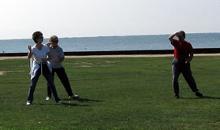 Tai Chi in the Park (August 16, 2008): The mornings break is always an opportunity to play and learn  demonstrated here by two students from Water Tiger Schools Sachem Public Library class seeking advice from Si-Suk Paul Adago, Jr., on the finer points of Fair Lady Weaves at Shuttles from the 24-Posture Form.