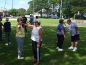 Tai Chi in the Park (August 23, 2008): Under the shade of the trees in Father Tortora Park, Si-Goo Mui Francesca DeStefano (not pictured) helps participants understand the Tai Chi principle of song (dynamic relaxation) with Water Tiger Schools Arm Drop exercise.