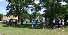 Tai Chi in the Park (August 23, 2008): Playing in the shade and next to trees in Father Tortora Park is something new for participants, who are accustomed to sun and wind and the view of the bay in Shorefront Park. Also new for them is experiencing Si-Hing Joel Valerio (2nd from L) leading Turn Heaven and Earth in Front of the Body from Water Tigers Tai Chi Qigong Breathing Set.
