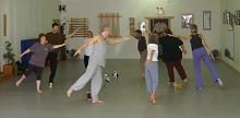 In the Kwoon, Grace of the Crane (September 2008): Laoshi Laurince McElroy (center) leads seminar participants in the Crane Gliding from the Wu-Dang Five Animal Frolics as they walk the traditional circular pattern marked this time by a monkey, a tiger, a bear, a heron (you try finding a plush crane), and  for reasons unknown  Odie from Garfield fame.
