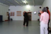 In the Kwoon, Joel Valerios Public Class Certification Ceremony (September 6, 2009): What can we say?  Were huggers at Water Tiger School.  This hug between Laoshi Laurince McElroy (R) and Si-Suk Joel Valerio (L) brings the days ceremony to a close.