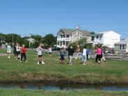 Tai Chi in the Park (August 28, 2010): On an absolutely gorgeous morning, Laoshi Laurince McElroy (C - in grey tank) leads the group in a circle walk of Tiger Walking from the Five Animal Frolics.