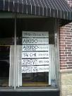 The Kwoon; 29 South Ocean; Patchogue, NY USA (October 2010): Complying with village regulations required rethinking the storefronts window signage.  The new placards list each of the programs that currently share the space.