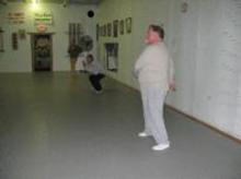 In the Kwoon (November 18, 2012): Students do their own thing for their pre-class warm-ups. Here (L to R) are Lem Coley playing Activate the Torso, Mark Famighette executing some Prayer Squats, and Mark Williams trimming Turn & Circle down to Turn.