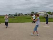Tai Chi in the Park (June 8, 2013): Laoshi Laurince McElroy turns sideways to show the detail of Playing the Pi Pa from Water Tiger Schools 24-Posture  Short Form in an exercise abbreviating the movements of the form down to the first four postures.