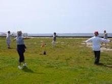 Tai Chi in the Park (June 22, 2013): Using a practice Dao and his tea bottle to mark the center of the circle walk, Laoshi Laurince McElroy (far R) introduces the mornings participants to Crane Flying from The Five Animal Frolics.