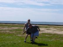 Laoshi Laurince McElroy demonstrating the basic martial application of Rollback with Mark Williams. Ya' gotta love it when people come to the park to get thrown around for free!