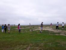 Laoshi Laurince McElroy takes the morning's focus of Bear Walking from the Five Animal Frolics into a circle walk with the morning's event participants