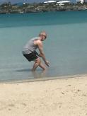 Sapodilla Bay on Providenciales, Turks & Caicos (August 22, 2018): McElroy Laoshi in Needle at Sea Bottom from the 24-Posture Form, reaching as low as he can go in the actual sea of the Northern Caribbean.