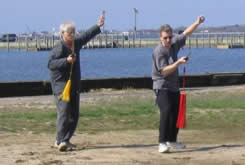 World T’ai Chi & Qigong Day; Shorefront Park, Patchogue NY (April 24, 2004): Event host Laoshi Laurince McElroy (R) and Mr. Phil White, event participant and fellow member of the MSN T’ai Chi Club, playing an orthodox straight sword form.