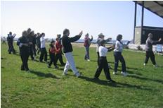 World Tai Chi & Qigong Day; Shorefront Park, Patchogue NY (April 29, 2006): Laoshi Laurince McElroy helping participants stretch like Tigers during his workshop on the Tiger Frolics.
